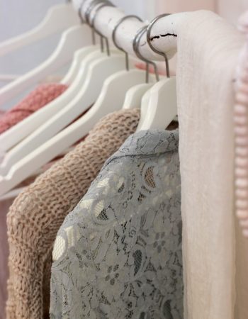 clothes hanging on white rack